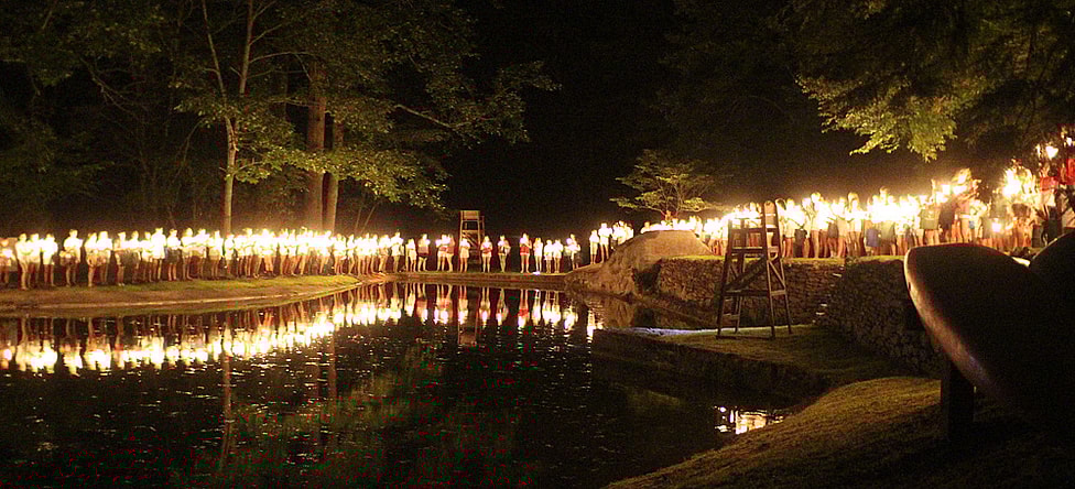 camp spirit candle ceremony around lake