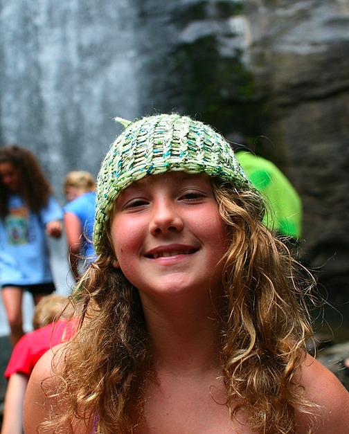 knitting camp girl wearing a hat she made