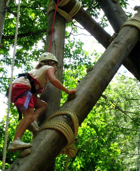 Girl climbing high ropes courses