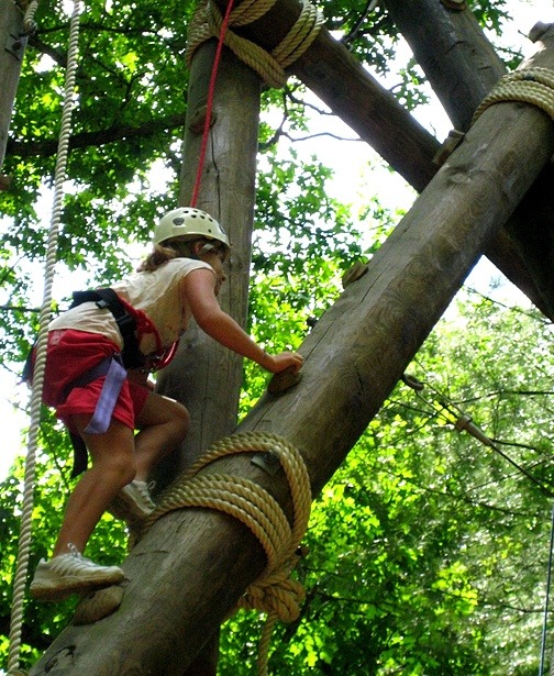 Girl climbing high ropes courses