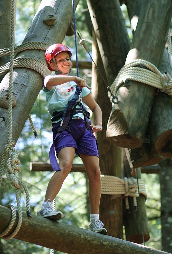 Youth girls climbing adventure ropes course