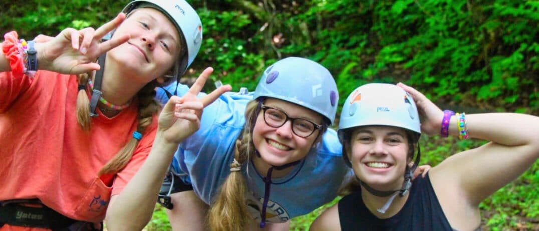 Climbing teenager kids at summer camp