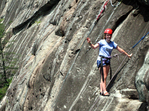 kid rock climbing on wall face