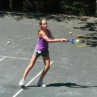 playing a game of tennis at summer camp