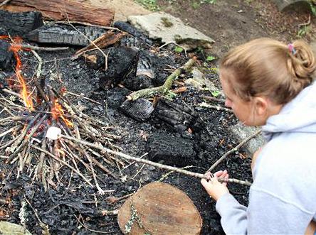 Learning to build a fire at summer camp