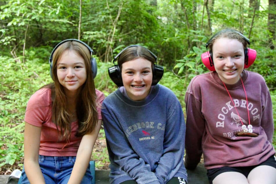 girls at camp rifle range wearing ear protection