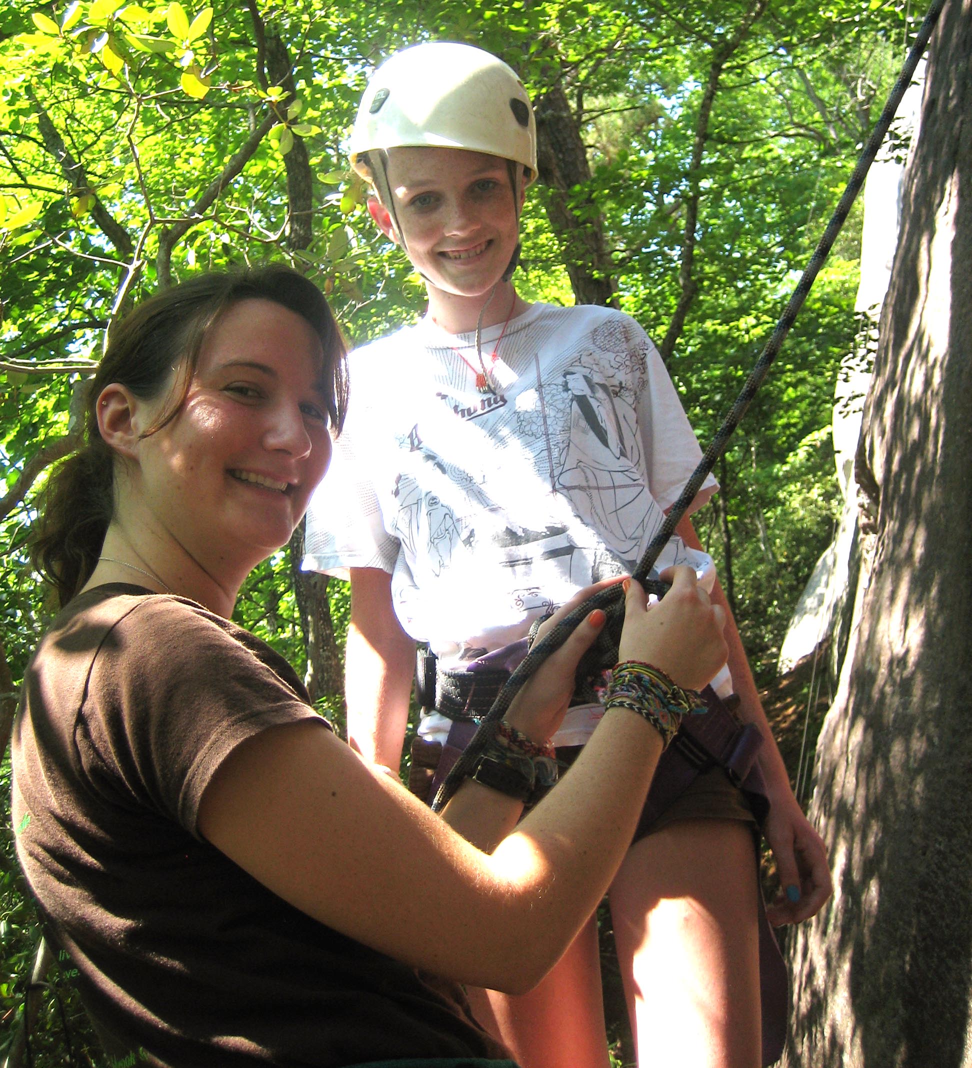 Lexie helping a camper to climb