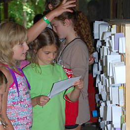 Girls receiving mail at summer camp