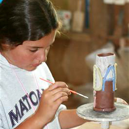 Camp girls painting ceramics pieces