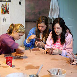Girls making ceramics at summer camp