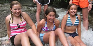 Girls ready to slide down the rock