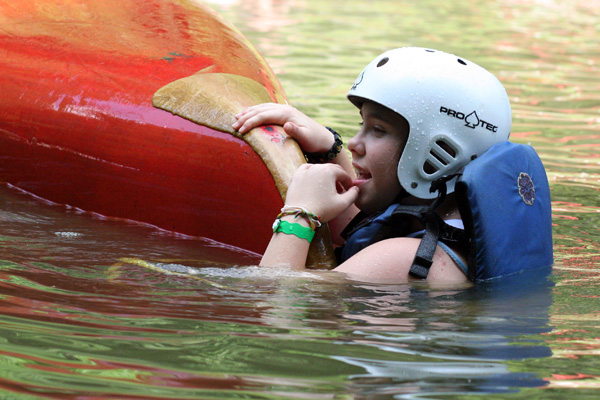 Canoe kid in the water with canoe outdoors