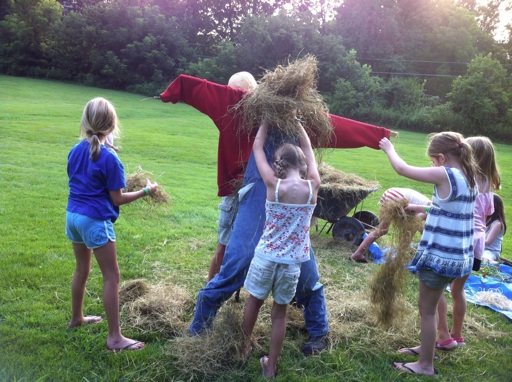 camp kids making a scarecrow
