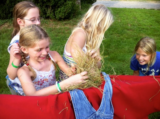 stuffing hay into a scarecrow