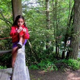 young camp girl learning to knit