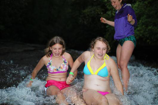 Camp children going down sliding rock