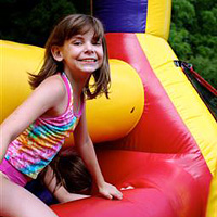 Camper on obstacle course during camp carnival