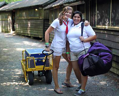 Two camper girls moving luggage