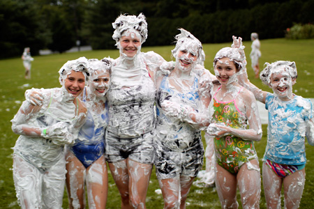 Camp girls in group shaving cream fight
