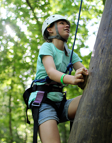 Girl climbing alpine tower