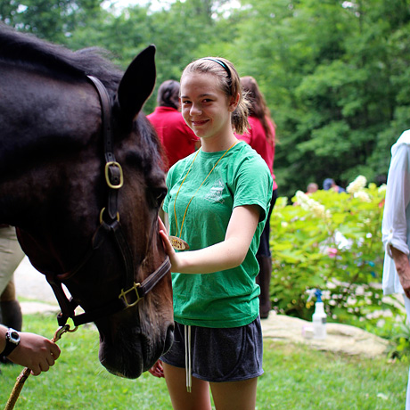 Greeting her first camp horse