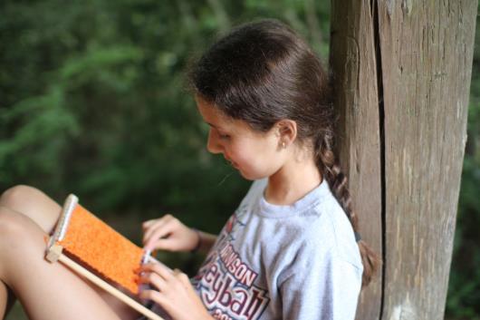 Lap loom weaving girl