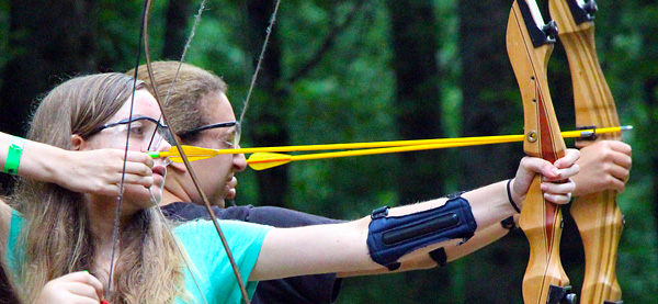 Pair of girls shooting archery