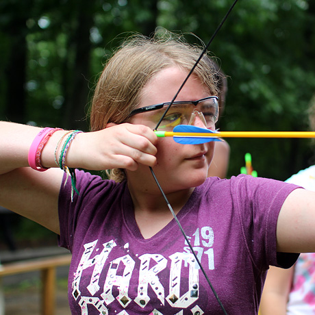 Girl archer aiming her arrow