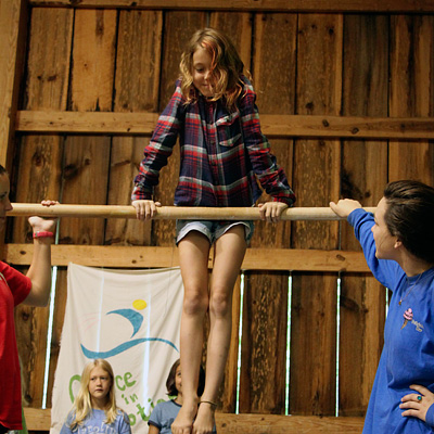 Camp girl on gymnastics bar