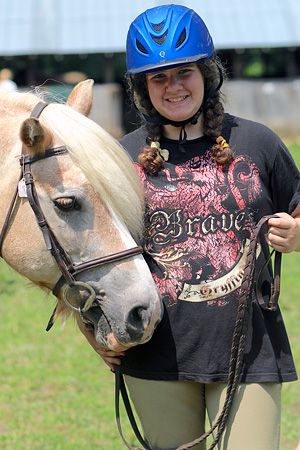 Girl camp camper posing with horse
