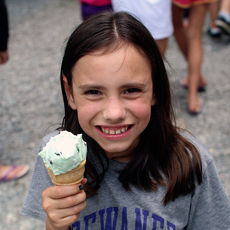 Summer camp kid eating ice cream cone