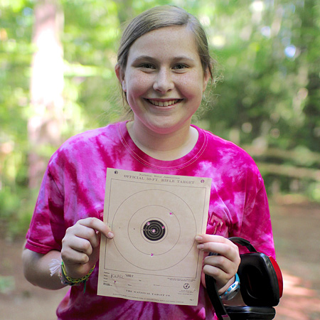 Kid holding her riflery target