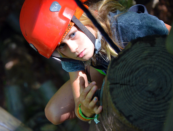 Girl concentrating on climbing tower