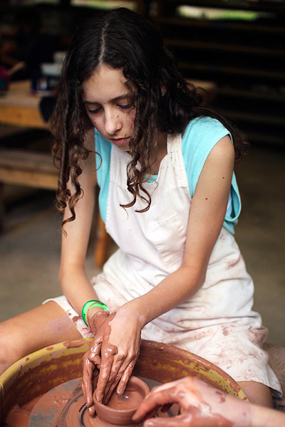 Throwing pottery on the wheel