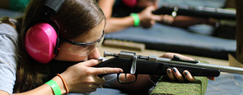 Child aiming a rifle