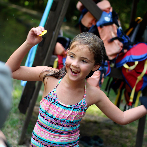 Camp girl gets swim tag after test