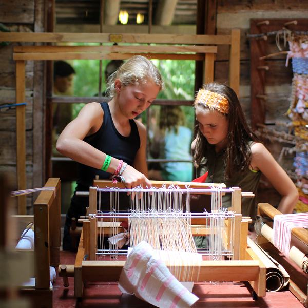 Girls working on loom weaving