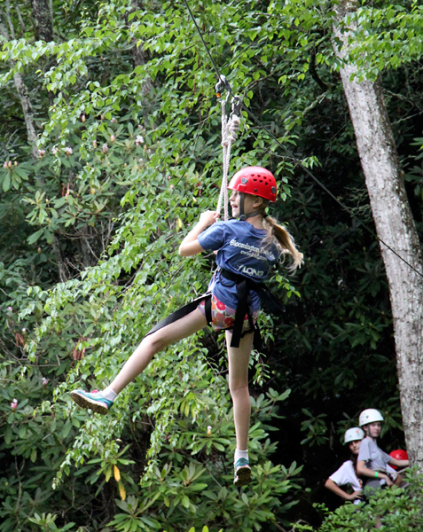 Kid flying on camp zipline