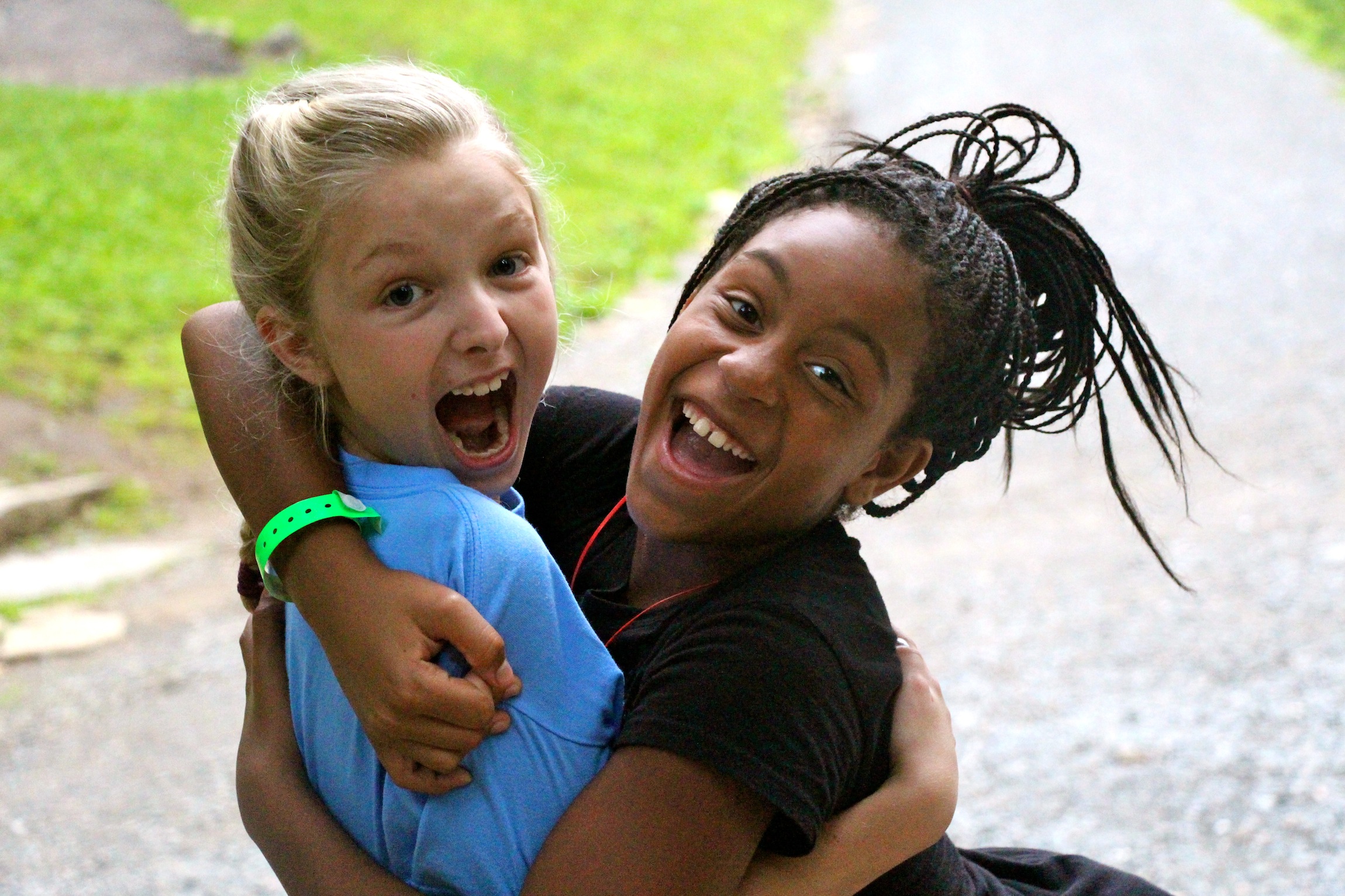 white and black camp kids hugging