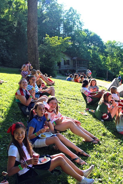 Eating cookout picnic on Hill at summer camp