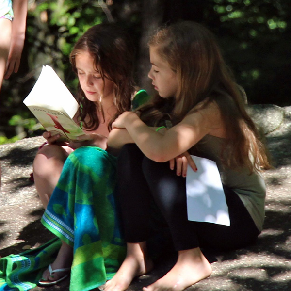 Girls reading during free time at camp