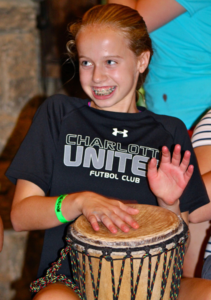 Camp girl learning to drum