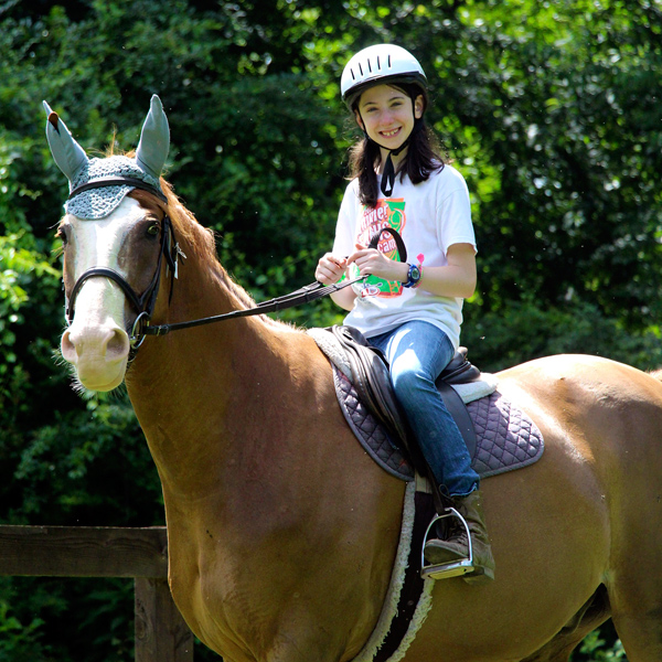 Summer camp horseback riding girl