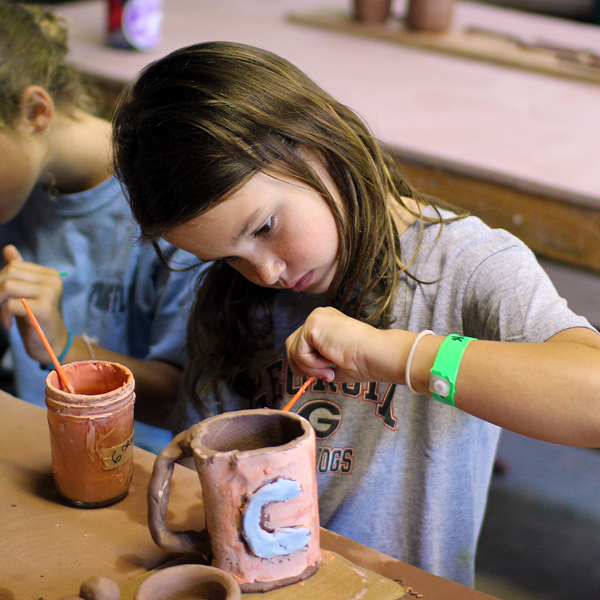 Pottery Glazing child at summer camp