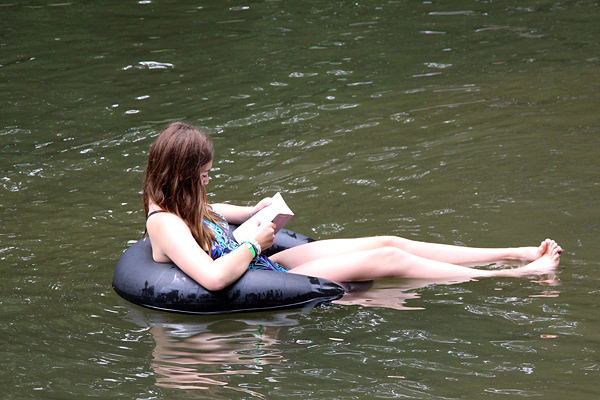 Reading a book floating in the lake