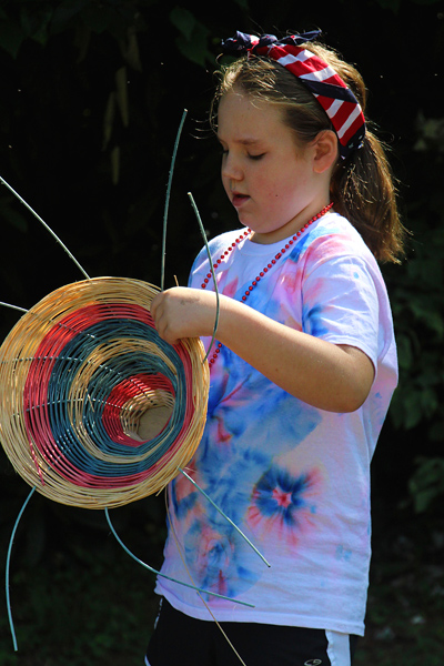 Camp girl making a USA basket