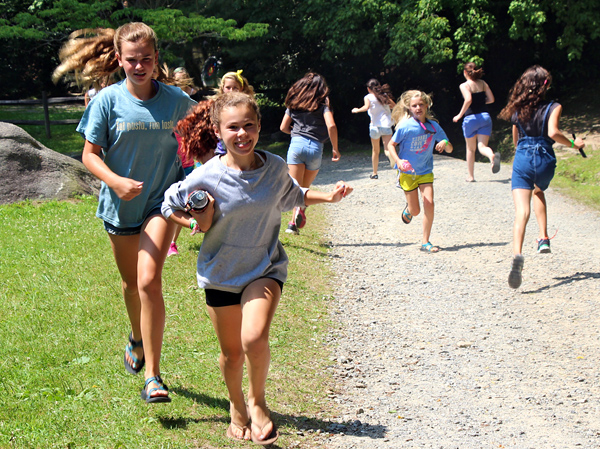 Girls running around camp
