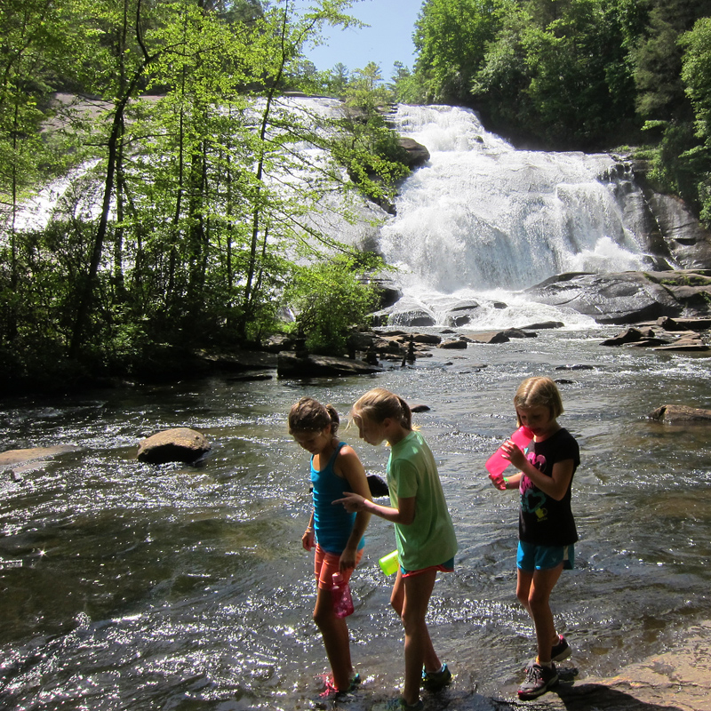 Camp girls exploring a waterfall