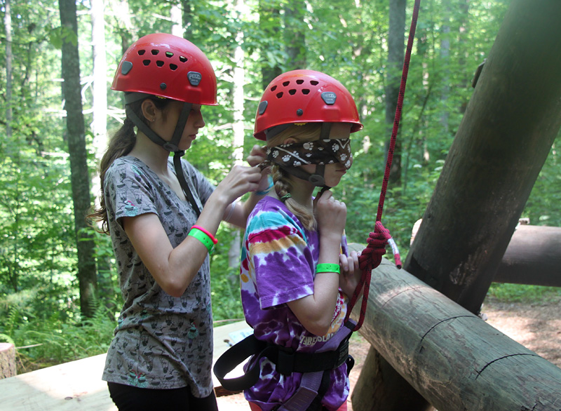 Blind Folded Camper Climbing