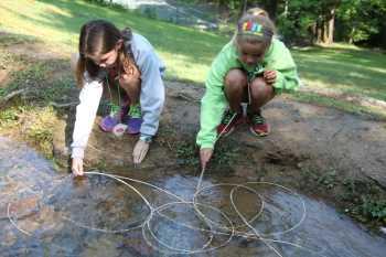 soaking weaving reeds in creek